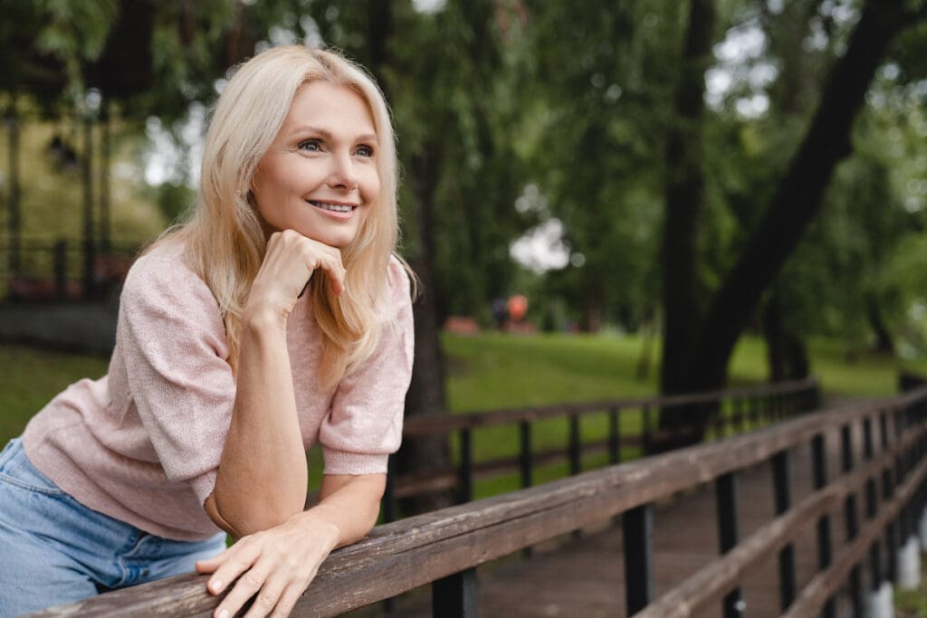 middle aged woman looking into the distance.
